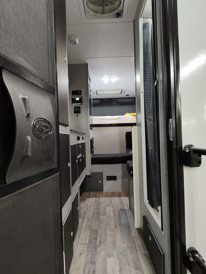 The interior of an rv with a black and white floor.