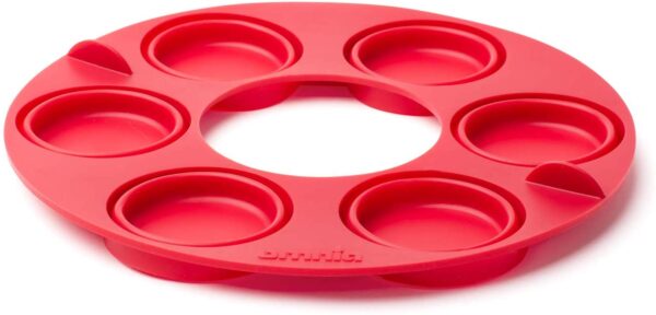 A red silicone Muffin Ring with six compartments.