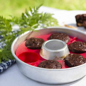 A metal Muffin Ring with cupcakes in it.