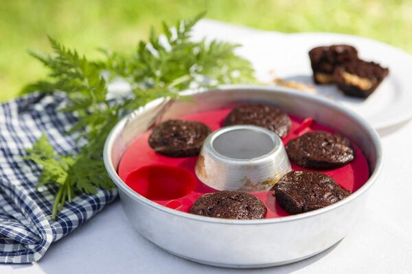 A metal Muffin Ring with cupcakes in it.