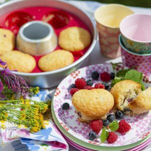 A plate with Muffin Ring and berries on it.