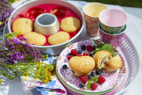 A plate with Muffin Ring and berries on it.