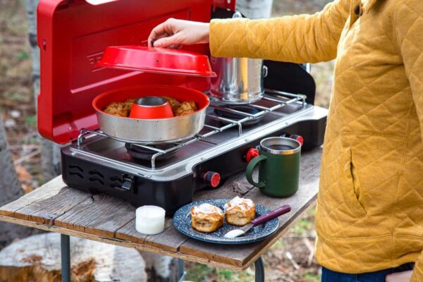 A woman is preparing food on an Omnia Oven.