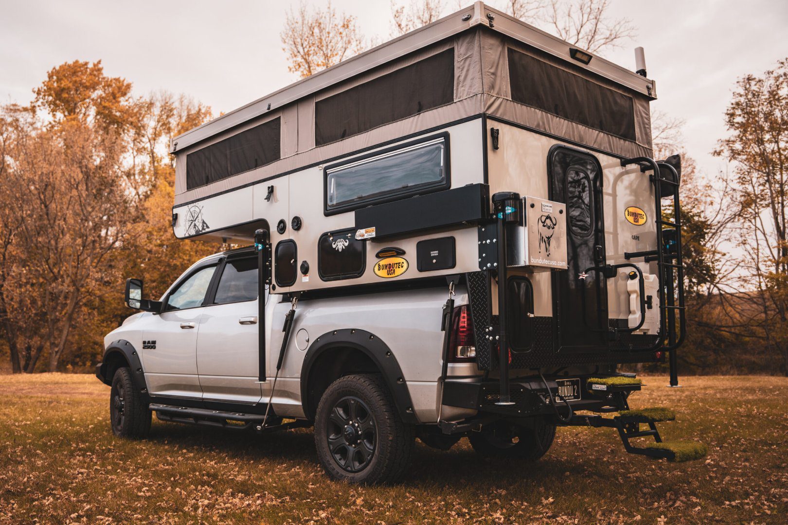 A truck with an rv on the back of it.