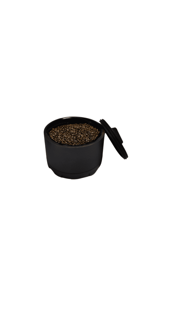 Black container with roasted coffee beans.