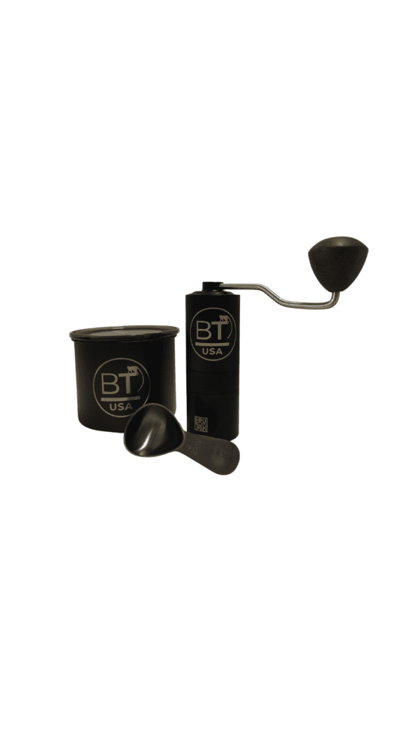 Black hand crank coffee grinder with scoop.