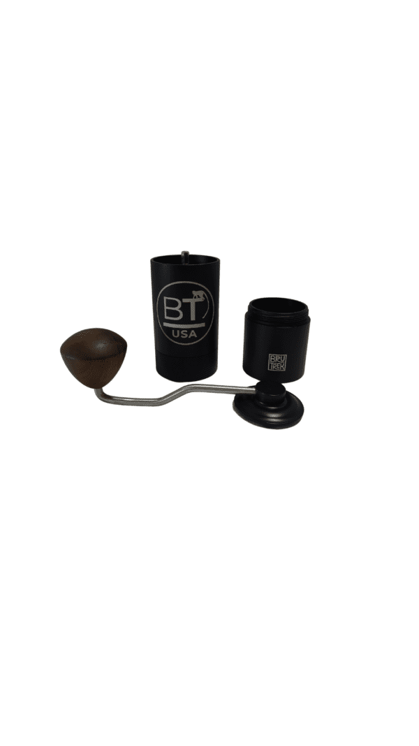 Black hand crank coffee grinder with wooden handle.