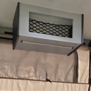 Overhead storage compartment with mesh netting.