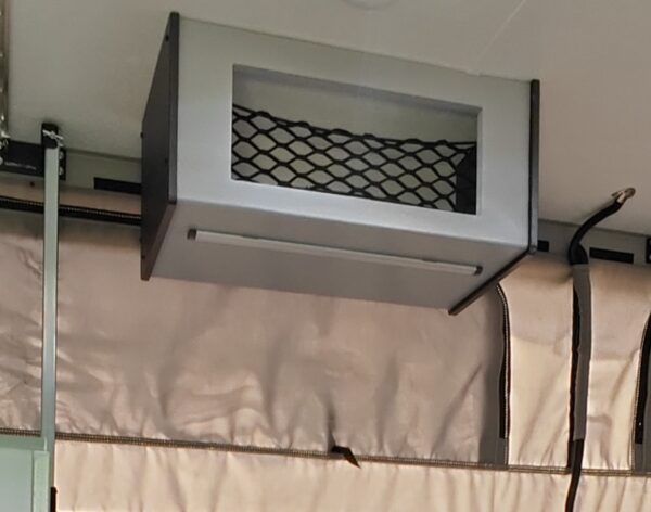 Overhead storage compartment with mesh netting.