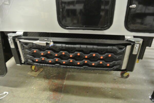 Black rubber step with orange accents.