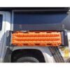 Orange traction mats mounted on a truck.