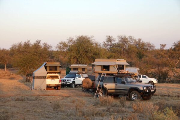 Campsite with multiple cars and tents.