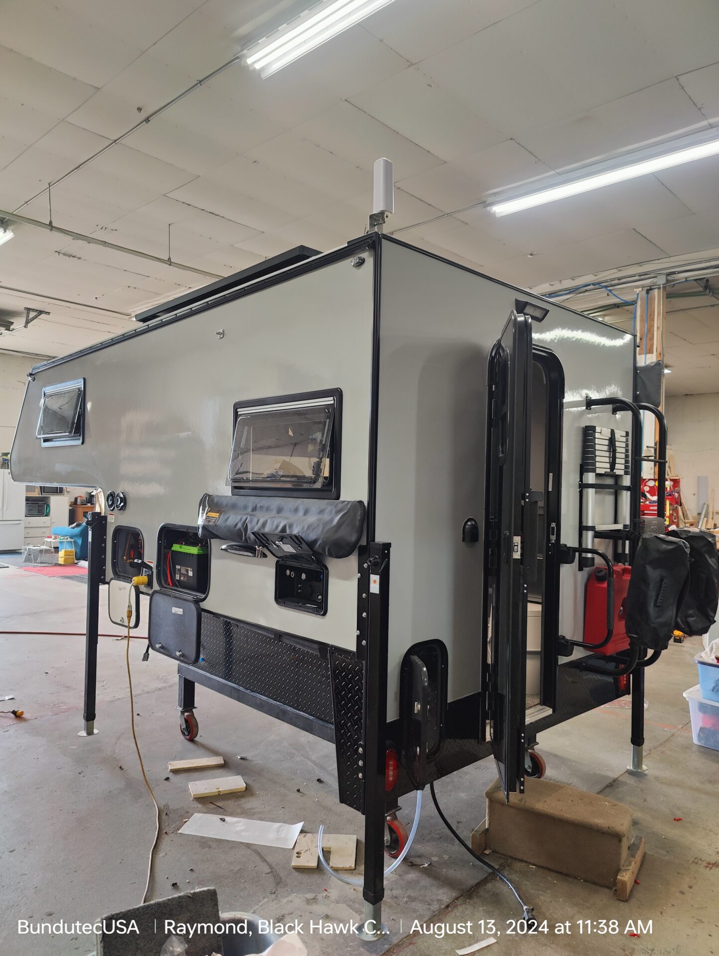 A camper trailer is being built in the garage.