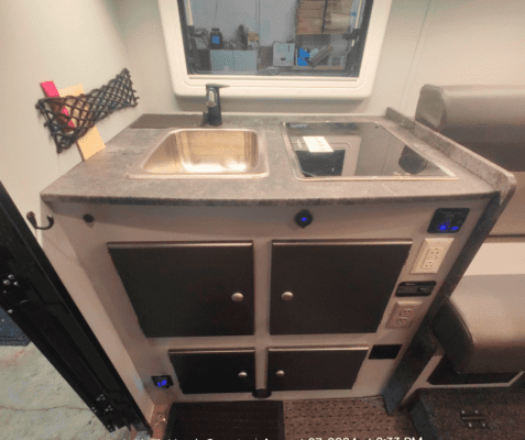 A kitchen with an oven and sink in it