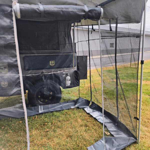 A tent that is covered by plastic tarps.