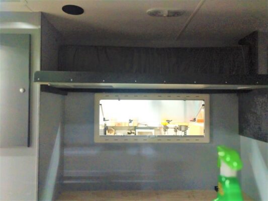 Interior with shelf and small window.