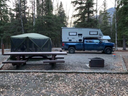 Camping setup with truck and tent.