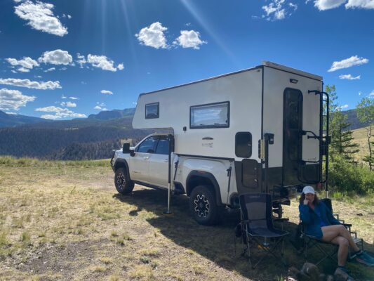 Truck camper in scenic mountain landscape.