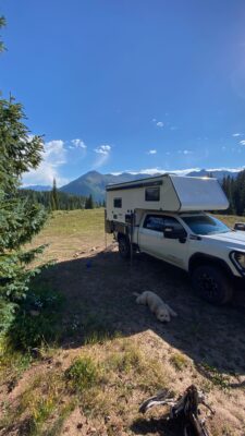 Camper truck parked in scenic mountain landscape.