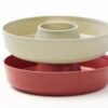 Stacked round baking pans, beige and red.